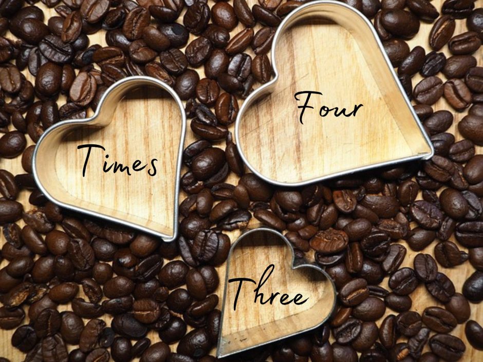 Three heart shaped cookie cutters among a bed of coffee beans. For a post about threesomes