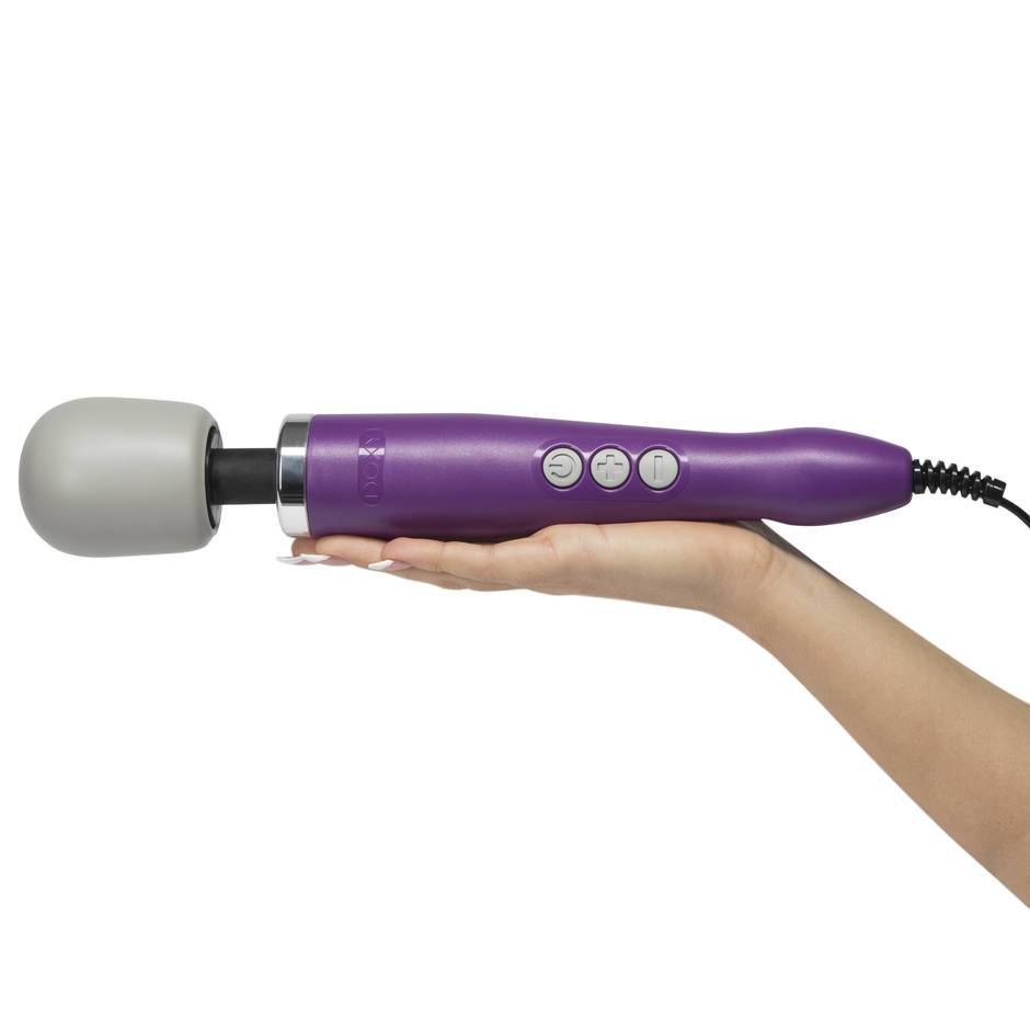 The Doxy Original, a purple wand style vibrator with a grey head, held on an upturned palm.