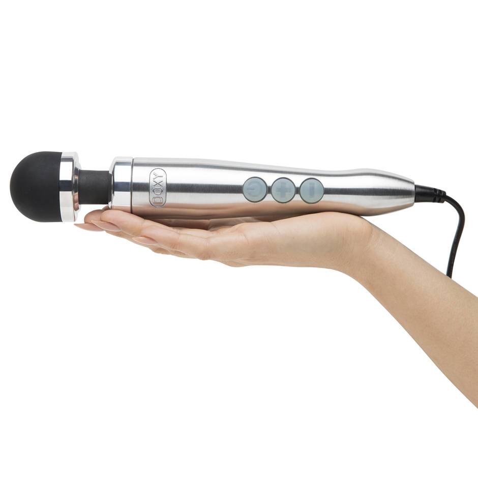 A white female upturned hand holding the Doxy Number 3, a small silver wand vibrator with a black head.