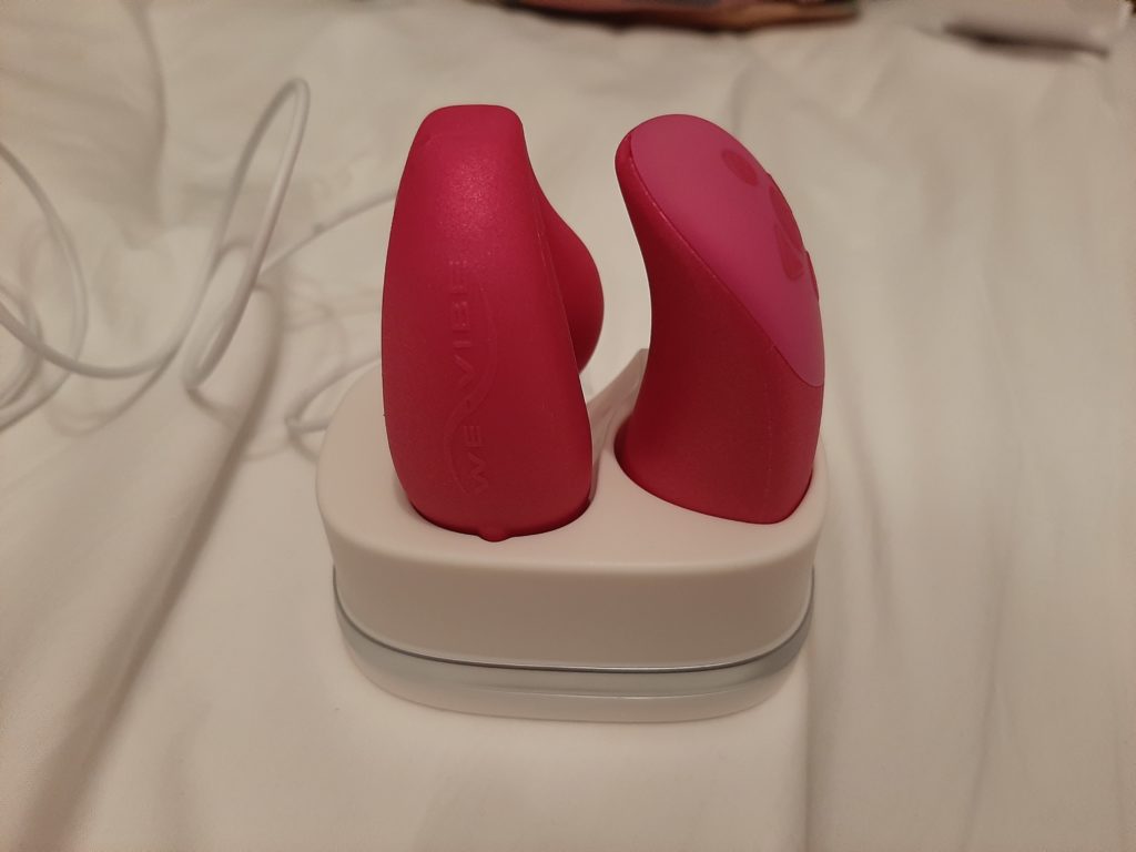 The WeVibe Chorus and remote on the docking stand