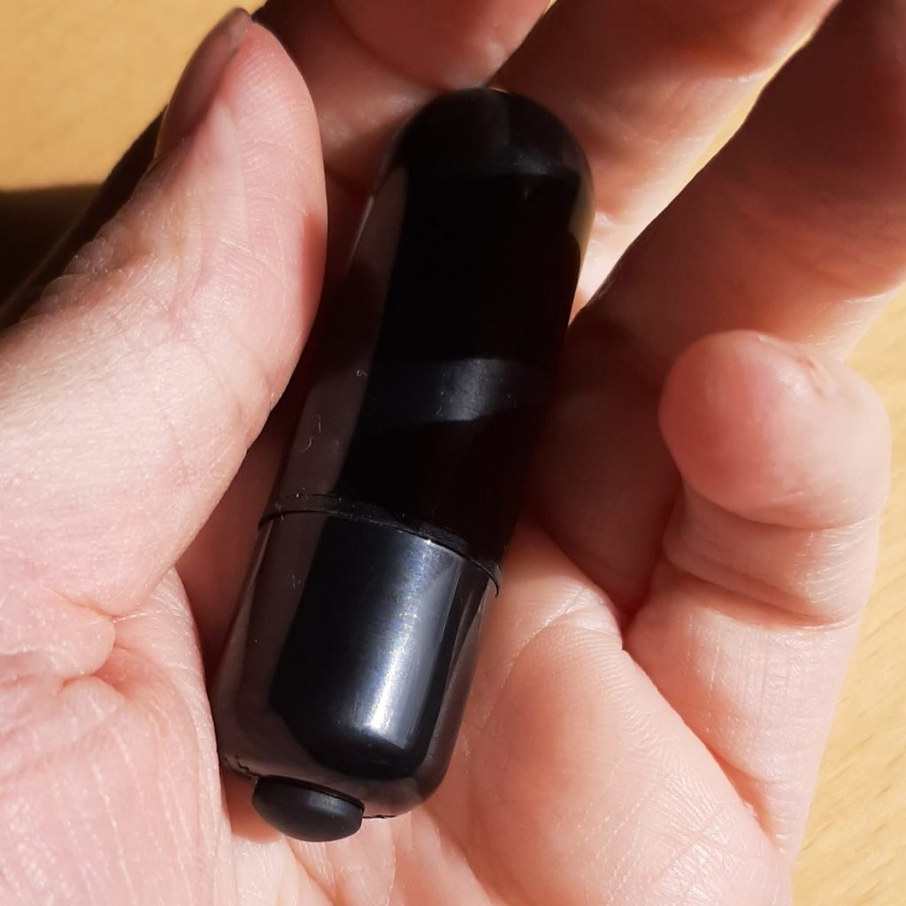 Black mini bullet vibrator for clitoral pleasure