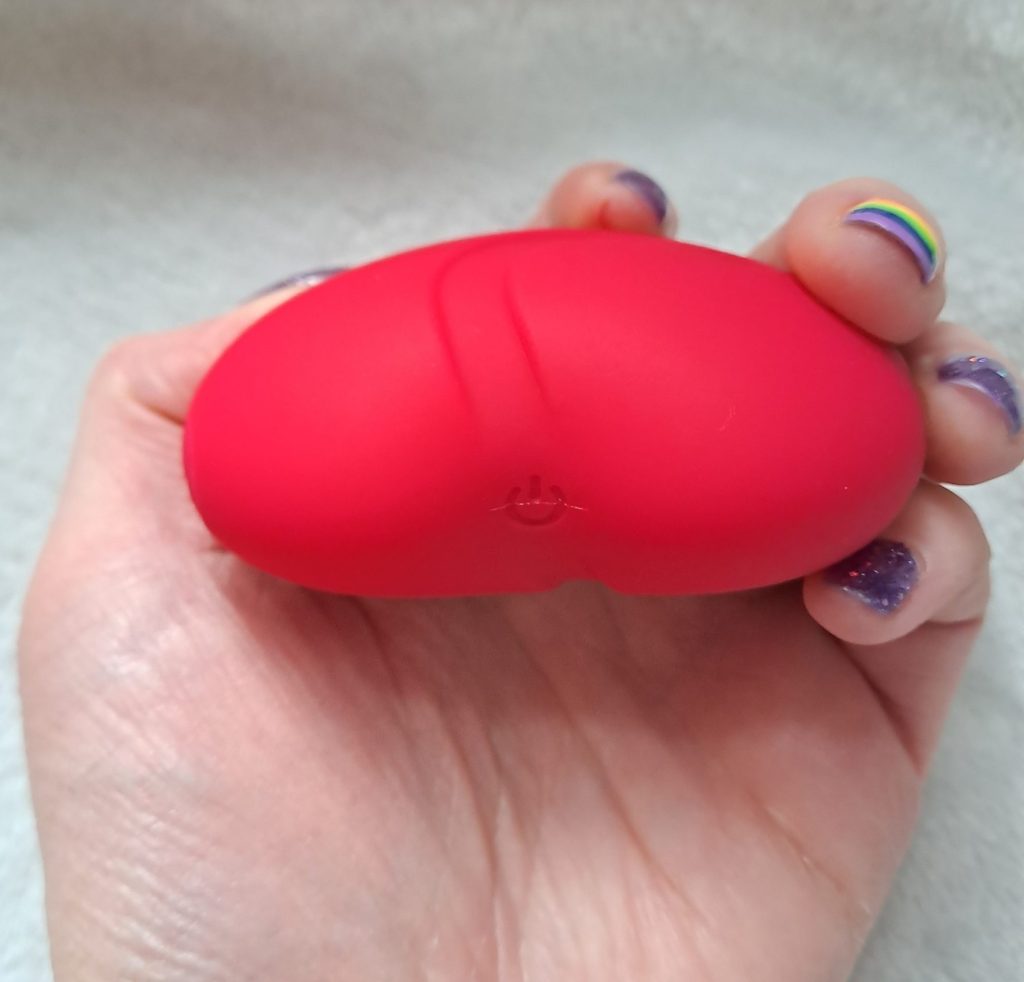 Lovehoney Heart Throb red heart massager end-on, showing the button