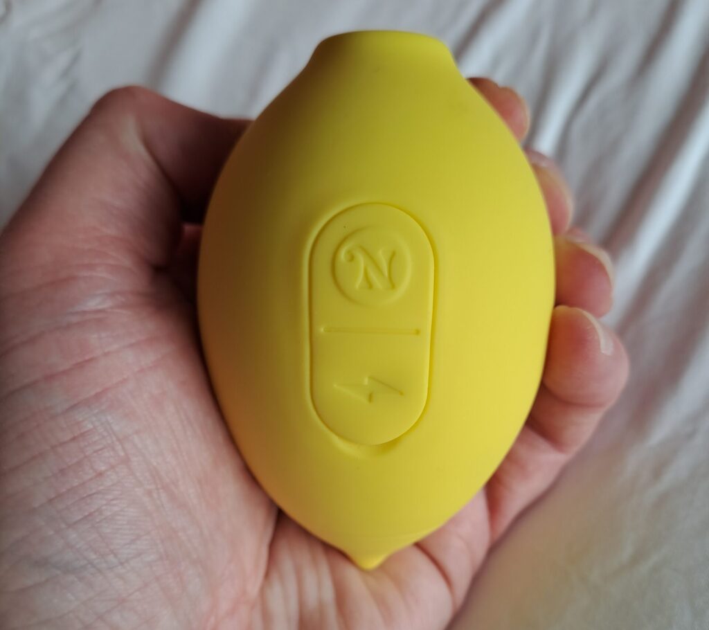 Hello Nancy Lem lemon vibrator held in a woman's hand