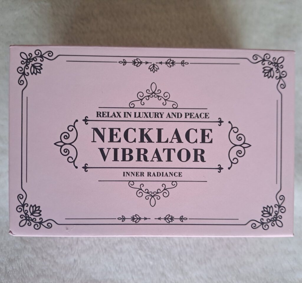 Pink box with black text reading "necklace vibrator"