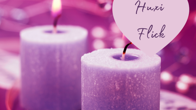 Two lit purple candles. Text reads: Huxi Flick
